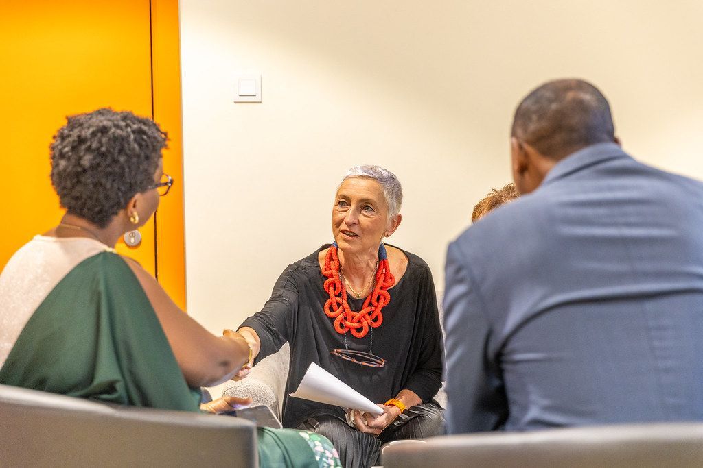 Professional consultant shaking hands with a client during a successful business meeting in a modern office space.
