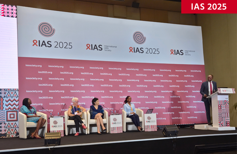 Panel discussion at IAS 2025 conference with a speaker at the lectern and four panelists on stage under event branding.